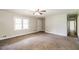 Spacious living room with carpet, ceiling fan, and natural light at 263 Austin Rd, Stockbridge, GA 30281