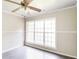 Bright room with modern wood-look tile, wainscoting, and a lighted ceiling fan at 263 Austin Rd, Stockbridge, GA 30281