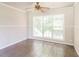 Bright room featuring tile flooring, wainscoting, ceiling fan and large window offering an abundance of natural light at 263 Austin Rd, Stockbridge, GA 30281