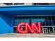 Exterior of the CNN Center building, showcasing its blue facade and the iconic CNN logo, with people walking nearby at 3272 Lions Ruby Ln, Atlanta, GA 30349