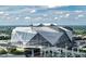 Aerial view of Mercedes-Benz Stadium showcasing its unique architecture, surrounding cityscape, and bright sky at 3272 Lions Ruby Ln, Atlanta, GA 30349