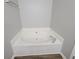 Bathroom with corner tub and neutral paint color scheme at 3838 Glenlake Springs Nw Ct, Kennesaw, GA 30144