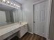 Bathroom with long countertop, drawers, and a large mirror with lighting at 3838 Glenlake Springs Nw Ct, Kennesaw, GA 30144