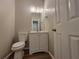 Updated bathroom with modern vanity, toilet, and hardwood style flooring at 3838 Glenlake Springs Nw Ct, Kennesaw, GA 30144