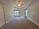 Spacious carpeted bedroom with tray ceilings and multiple windows at 3838 Glenlake Springs Nw Ct, Kennesaw, GA 30144