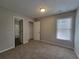 Bright bedroom features neutral walls, carpet flooring, and a closet at 3838 Glenlake Springs Nw Ct, Kennesaw, GA 30144