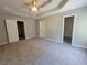 Large primary bedroom featuring a tray ceiling, carpeted floor, and walk-in closet at 3838 Glenlake Springs Nw Ct, Kennesaw, GA 30144