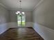 Dining room featuring updated floors, wainscoting detail, and a stylish light fixture at 3838 Glenlake Springs Nw Ct, Kennesaw, GA 30144