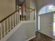 Bright entryway featuring wood-look floors, staircase with white trim, and arched doorway at 3838 Glenlake Springs Nw Ct, Kennesaw, GA 30144