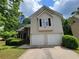 Two-story house with vinyl siding, brick accents, a two-car garage, and a well-maintained lawn at 3838 Glenlake Springs Nw Ct, Kennesaw, GA 30144