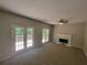 Spacious living room featuring a fireplace and double doors to the outside deck at 3838 Glenlake Springs Nw Ct, Kennesaw, GA 30144
