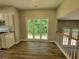 Bright Living space featuring hardwood floors and an open view of the kitchen and deck access at 3838 Glenlake Springs Nw Ct, Kennesaw, GA 30144
