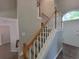 Carpeted staircase with white banister and wooden handrail to the second story at 3838 Glenlake Springs Nw Ct, Kennesaw, GA 30144