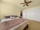 Comfortable bedroom features a ceiling fan, plush bed and a closet at 59 Townview Dr, Alpharetta, GA 30022