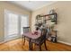 Dining area with a table and chairs next to french doors, complemented by a shelf with books and plants at 59 Townview Dr, Alpharetta, GA 30022