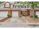 Attractive brick townhome featuring an attached garage, well maintained landscaping, and inviting curb appeal at 59 Townview Dr, Alpharetta, GA 30022