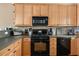 Close-up of the kitchen, showcasing modern black appliances and light wood cabinets at 59 Townview Dr, Alpharetta, GA 30022