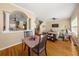 Open-concept living room with dining area, hardwood floors, natural light, and comfortable seating arrangements at 59 Townview Dr, Alpharetta, GA 30022