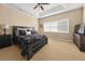 Main bedroom with a king bed, lamps, dresser, and a large window at 59 Townview Dr, Alpharetta, GA 30022