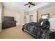 This is a spacious main bedroom with neutral walls, tray ceilings, a ceiling fan, and a seating area at 59 Townview Dr, Alpharetta, GA 30022