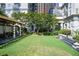 Beautiful backyard with lush lawn, pergola-covered patio, and manicured landscaping at 199 14Th St # 409, Atlanta, GA 30309