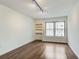 Cozy bedroom featuring hardwood floors, track lighting, and a window with natural light at 199 14Th St # 409, Atlanta, GA 30309