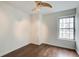 Cozy bedroom features a ceiling fan, wood floors, and a window offering natural light at 199 14Th St # 409, Atlanta, GA 30309