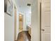 Hallway leading to a bathroom with a wood floor and neutral walls at 199 14Th St # 409, Atlanta, GA 30309