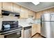 Functional kitchen featuring stainless steel appliances and wooden cabinets at 199 14Th St # 409, Atlanta, GA 30309