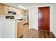 Compact kitchen with wooden cabinetry, stainless steel appliances, and hardwood floors at 199 14Th St # 409, Atlanta, GA 30309