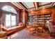 The library has a wall of bookshelves, seating and a window seat with views at 199 14Th St # 409, Atlanta, GA 30309