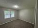 A bright carpeted bedroom featuring a window at 2184 River Acres Ct, Lithonia, GA 30058