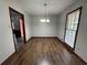 Bright dining room featuring hardwood floors, a modern chandelier, and natural light from large windows at 2184 River Acres Ct, Lithonia, GA 30058