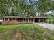 Charming one-story home featuring a brick foundation and a covered carport for convenient parking at 2184 River Acres Ct, Lithonia, GA 30058