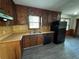 Practical kitchen with wood cabinetry, updated flooring, and essential appliances for everyday cooking at 2184 River Acres Ct, Lithonia, GA 30058
