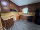 Functional kitchen featuring classic wood cabinets, laminate countertops, and updated flooring at 2184 River Acres Ct, Lithonia, GA 30058