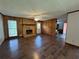Inviting living room with brick fireplace, wood paneling, and gleaming hardwood floors at 2184 River Acres Ct, Lithonia, GA 30058