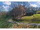 Scenic aerial view of a cabin-style home with a green metal roof and a long winding driveway at 3721 Mason Creek Rd, Winston, GA 30187
