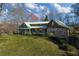 Charming cabin-style home with stone accents, a green metal roof, and a covered front porch at 3721 Mason Creek Rd, Winston, GA 30187