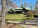 Charming cabin-style home with stone accents, a metal roof, and a covered front porch at 3721 Mason Creek Rd, Winston, GA 30187