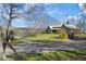 Scenic view of a log home featuring a stone exterior and a lush green lawn at 3721 Mason Creek Rd, Winston, GA 30187