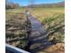 Scenic view of a gently flowing stream through grassy fields at 3721 Mason Creek Rd, Winston, GA 30187