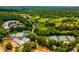 Expansive aerial view of golf course, tennis court and community center with lush landscaping at 388 Londonberry Road, Sandy Springs, GA 30327