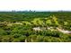 Aerial view of lush golf course, surrounded by green landscape and city skyline in background at 388 Londonberry Road, Sandy Springs, GA 30327