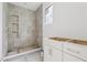 A stylish bathroom featuring a tiled shower with niche shelves and a modern vanity awaiting finishing touches at 388 Londonberry Road, Sandy Springs, GA 30327