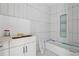Stylish bathroom with new, white tile, modern fixtures and the bathtub awaiting final installation at 388 Londonberry Road, Sandy Springs, GA 30327