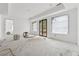 Large bedroom featuring recessed lighting, multiple windows, and access to the backyard at 388 Londonberry Road, Sandy Springs, GA 30327