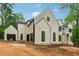 New construction home featuring modern architecture with dark trim and light stucco at 388 Londonberry Road, Sandy Springs, GA 30327