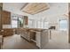 Large kitchen featuring custom wood cabinets, a central island, fireplace, and backyard views at 388 Londonberry Road, Sandy Springs, GA 30327