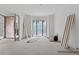 Spacious living room under construction with stone archway and door to patio at 388 Londonberry Road, Sandy Springs, GA 30327
